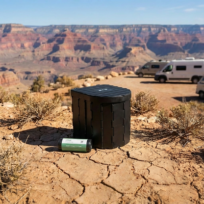 Black PlopEco Go Toilet Kit and 1 roll of PlopEco Bio Toilet Bags on a rocky desert landscape with Grand Canyon in the background